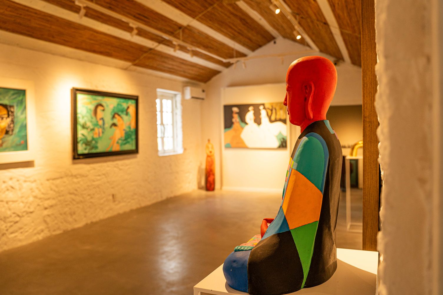Interior of an art gallery in Hoi An showcasing traditional Vietnamese paintings and crafts, a cultural thing to do in Hoi An.
