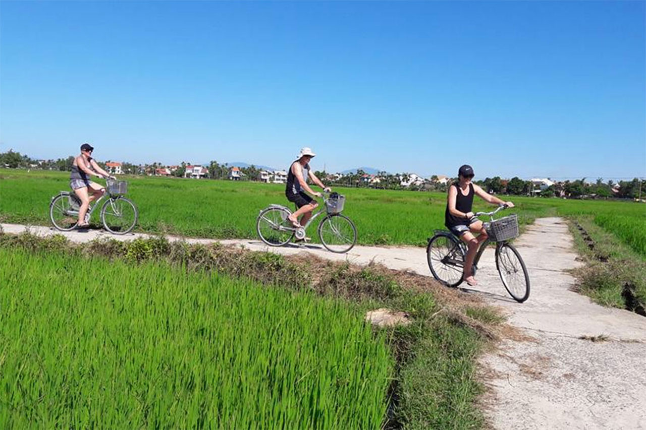 Traveler on a bicycle exploring hidden gems Hoi An countryside.